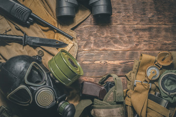 Post apocalypse soldier table concept background. Military equipment on old wooden background.