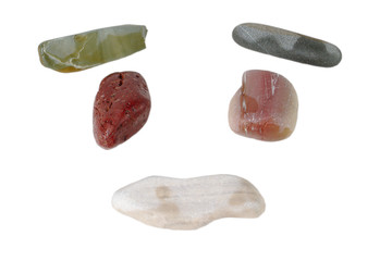 Several sea stones lie in the shape of a face. isolate