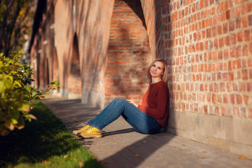 portrait of a young beautiful blonde in a hat on a background of the city of Moscow