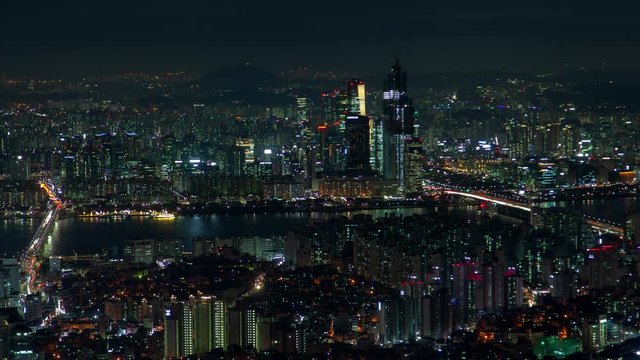 Timelapse large Seoul ocean bay and illuminated city with overpass roads connecting parts at night panning up