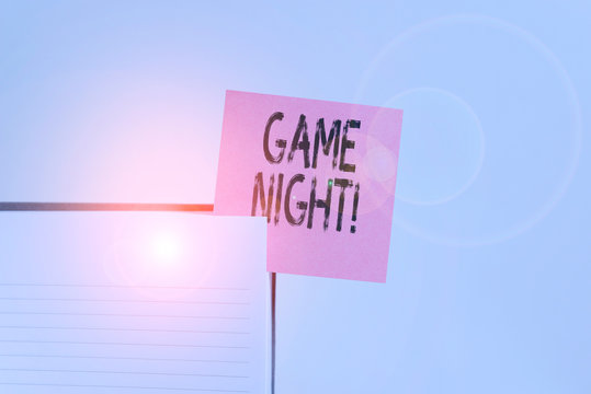 Text sign showing Game Night. Business photo showcasing usually its called on adult play dates like poker with friends Upper view lined hard cover note book sticky note inserted clear background