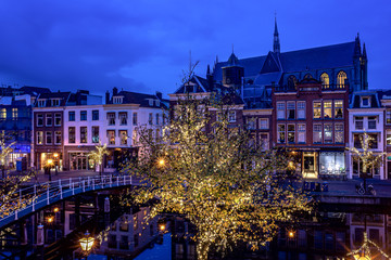Fototapeta na wymiar Leiden, Netherlands, 20 October 2019: Beautiful autumn night scene in Leiden, The Netherlands still reflections in the canal water