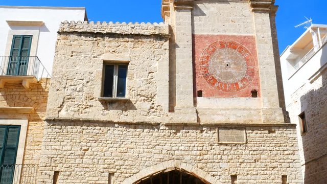 facade of the clock tower positioned in front of the cathedral of Bitetto near Bari, Apulia. Italy