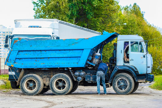 Moscow, Russia - September, 23, 2019: image of a driver fixing a truck