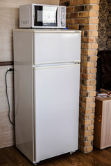 Brest, Belarus - August, 2, 2019: image of a refrigerator and a microwave oven in a hotel kitchen in Brest