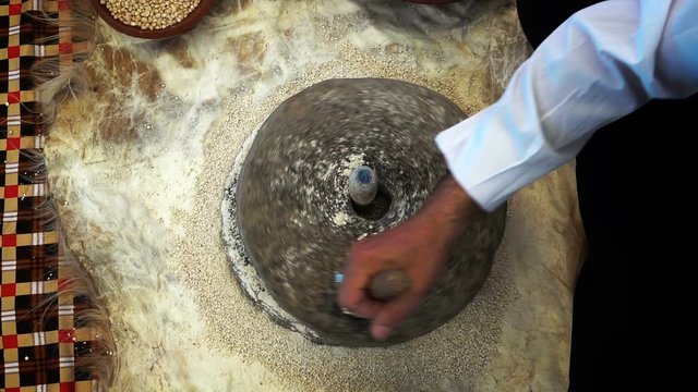 Crushing Wheat With Turning Stone to make Flour 