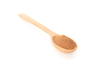 Wooden spoon with cinnamon powder isolated on white background