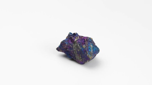 Mineral chalcopyrite on a white background.