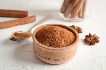 Cinnamon sticks, anise and spoon on white background, space for text