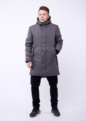 Fototapeta premium A man stand up wearing gray jacket isolated white at the studio.