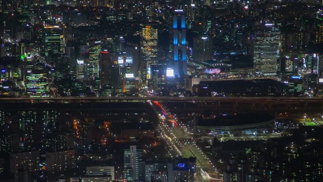 SEOUL/KOREA - MAY 29 2019: Timelapse illuminated flashing displays on Seoul modern buildings and overpass roads with river bridge at night pan up on May 29 in Seoul