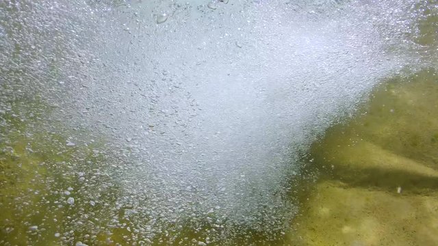 Air bubbles underwater in a flowing stream, Spain, La Muga river, Alt Emporda, Catalonia
