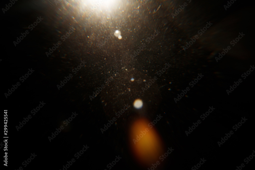 Aufkleber Lens Flare. Light over black background. Easy to add overlay or screen filter over photos. Abstract sun burst with digital lens flare background. Gleams rounded and hexagonal shapes, rainbow halo.