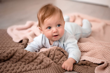 baby boy 3 months lying on his stomach at home