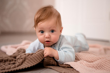 baby boy 3 months lying on his stomach at home