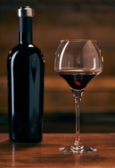 Glass of red wine on table at home