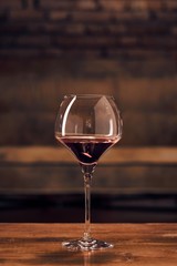 Glass of red wine on table at home
