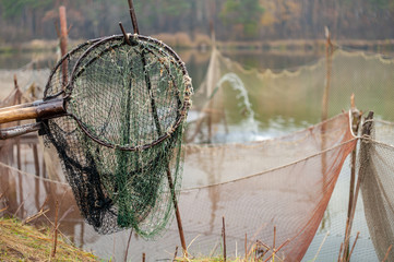 fishing nets and dip-net on forest lake background