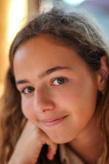 Portrait of a beautiful young girl with brown eyes. Charming teen girl.