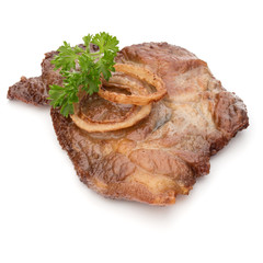 Cooked fried pork meat with parsley herb leaves and onion slices garnish isolated on white background cutout