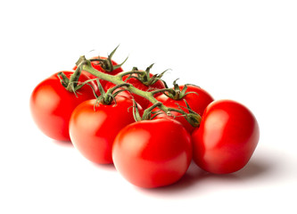 ripe tomatoes with lettuce leaves on a white background