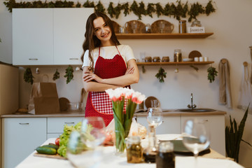 young woman in apron in the kitchen