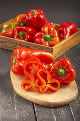 Fresh red peppers on black wooden background