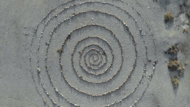 aerial top view and approximation  of a spiral stone path labyrinth,
