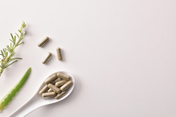 Background with capsules of natural medicine with pants white table - obrazy, fototapety, plakaty