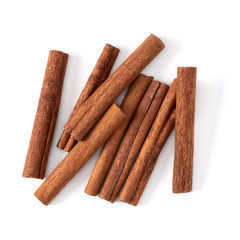 Cinnamon sticks isolated on white background closeup. Canella spice. Aromatic condiment background. Flat lay, top view.