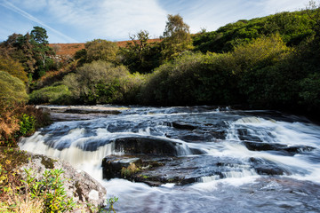 Scenic shot of small waterfalls on River Avon, Shipley Bridge, Avon Dam Reservoir, South Brent,...