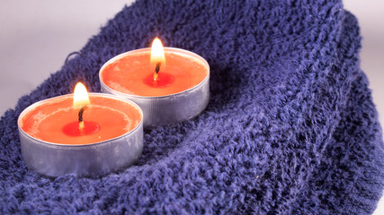 Fototapeta na wymiar Spa, tranquility and candlelight for relaxation and a towel