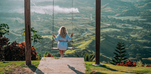 Beautiful view of young woman swing on the top of the mountain Redonda in Dominican Republic....