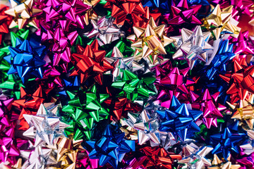 Background of many bows to decorate Christmas gifts of various colors.