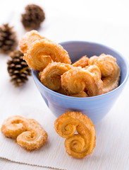 Christmas palmier cookies in a blue bowl