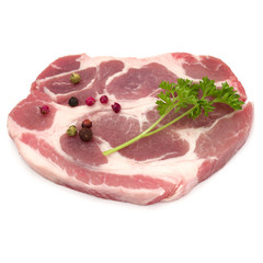 Raw pork neck chop meat with parsley herb leaves and peppercorn spices garnish isolated on white background cutout