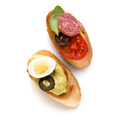 Open faced sandwich canape or crostini isolated on white background closeup. Top view.