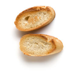 Toasted baguette slices isolated on white background close up.  Toast, crouton.   Top view.