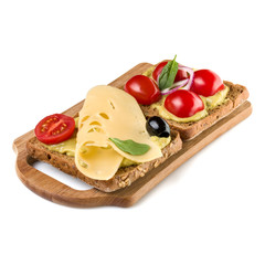 Open  faced vegetable sandwich canape or crostini on a wooden serving board  isolated on white background closeup. Vegetarian tartarine.