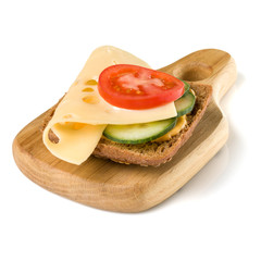 Open  faced cheese sandwich canape or crostini on a wooden serving board  isolated on white background closeup.  Vegetarian tartarine.