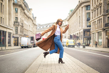 Fashionable business woman running in the street