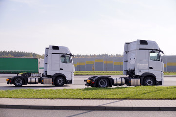 Obraz premium New trucks on the way to the customer. Travel break.