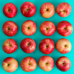 Fruit pattern of red apple on blue background. Flat lay, top view. Pop art design, creative summer concept. Food background.