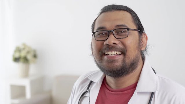 portrait of happy confident asian doctor smiling to camera