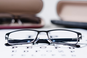 glasses and Eyeglasses on table of check of vision close up - Myopia or hyperopia