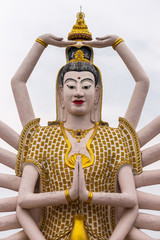 Obraz premium Ko Samui Island, Thailand - March 18, 2019: Wat Laem Suwannaram Chinese Buddhist Temple. Closeup of chest and heast of Giant Guan Yin goddess statue with 18 arms against silver sky.