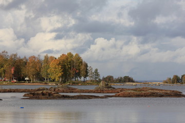 Rock formations and colorful trees at the shore of Lake Vanern, Sweden.