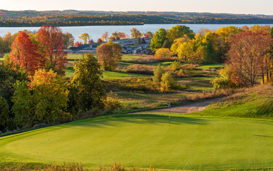 golf course on lake at sunrise in autumn