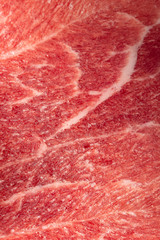 Texture of frozen fresh raw meat, close up, macro. Vertical frame.