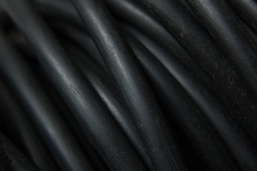 Abstract macro photography of black rubber coated cables.